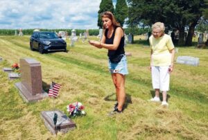 Kathryn Wilson Rhodes visits her brother Murlyn’s grave with granddaughter Lori Rhodes. It was Kathryn’s last visit to the gravesite after finding out she had terminal cancer. (Photo Contributed)