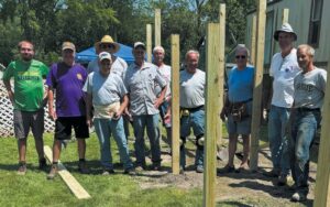 Lions working together to build wheelchair ramp. (In front) Bill Emmert. (Second row, from left) Shea Targgart, Alan Targgart, Greg Leatherman, Stan Jacob. (Back row, from left) Ron Jones, Duane Stohlman, Pete Hochstetler, Brad Igney, Rick Carmein. (Photo Contributed by Alan Taggart)