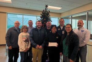 Executive Director Sara Patrick and Director of Marketing & Operations Ian Mullen accepting the final corporate donation to the cause by Miller Poultry. (Photo Contributed)